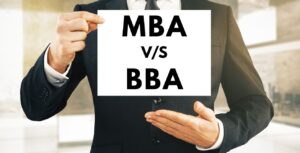 Man holding board showing differences between an MBA and a BBA